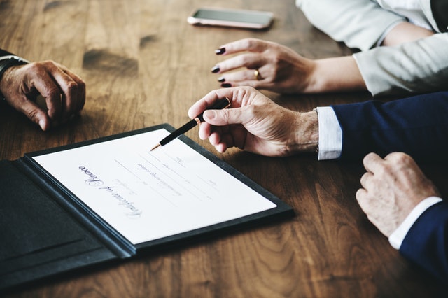 Three people reviewing a divorce document.